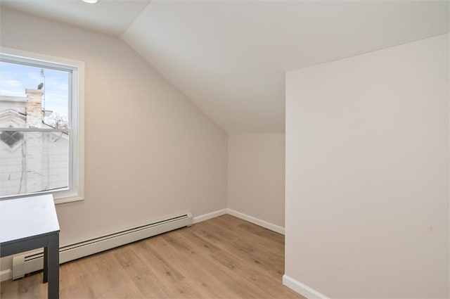 bonus room with a baseboard radiator, lofted ceiling, and light wood-type flooring