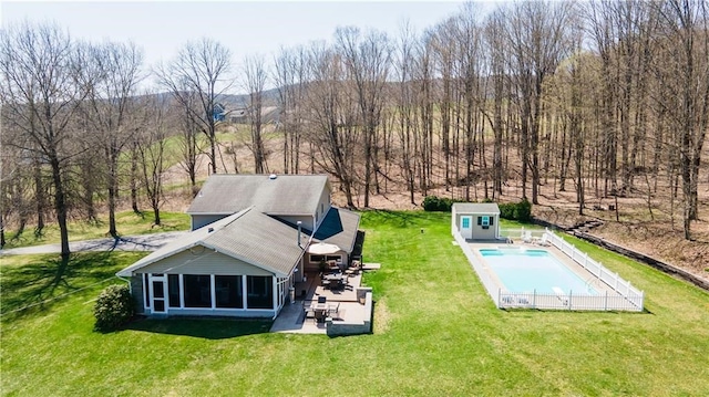 drone / aerial view with a shed, a lawn, and a patio area