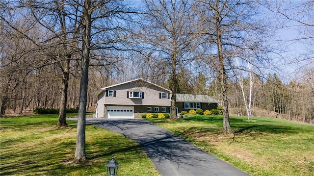 tri-level home with a front yard and a garage