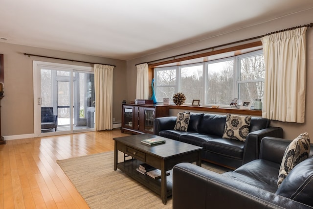 living room with light hardwood / wood-style floors and baseboard heating