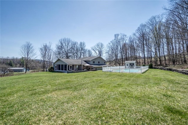 view of yard with a pool and a sunroom