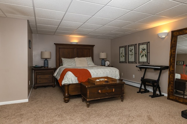 bedroom with baseboard heating, a drop ceiling, and light colored carpet