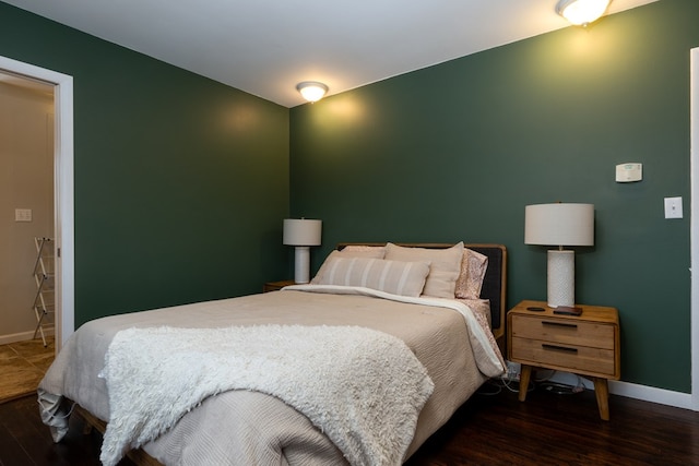 bedroom with dark wood-type flooring