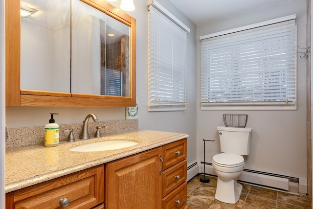 bathroom with vanity, toilet, and a baseboard heating unit