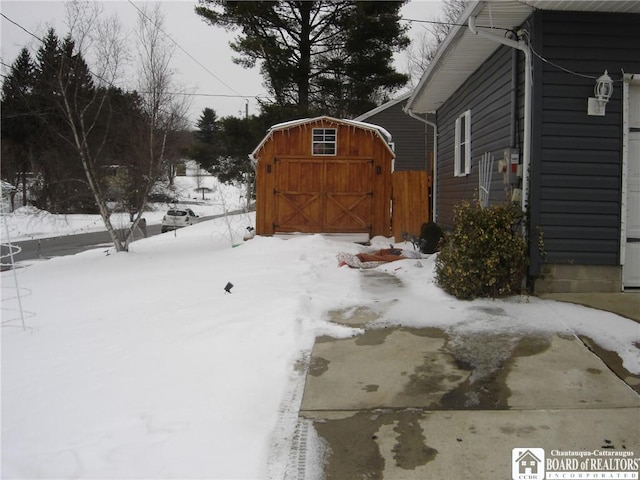 yard layered in snow with a shed