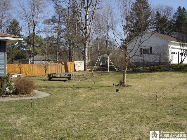 view of yard with a playground and fence