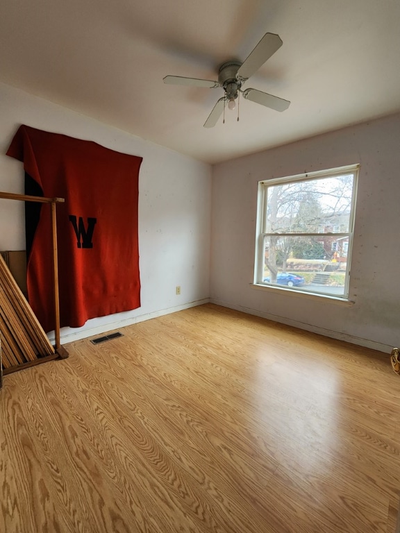 spare room with light hardwood / wood-style flooring and ceiling fan