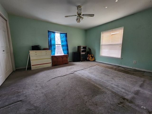 unfurnished bedroom with ceiling fan and carpet