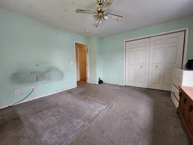 unfurnished bedroom with a closet, ceiling fan, and carpet flooring