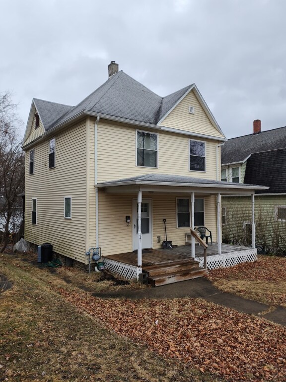 rear view of property featuring a porch