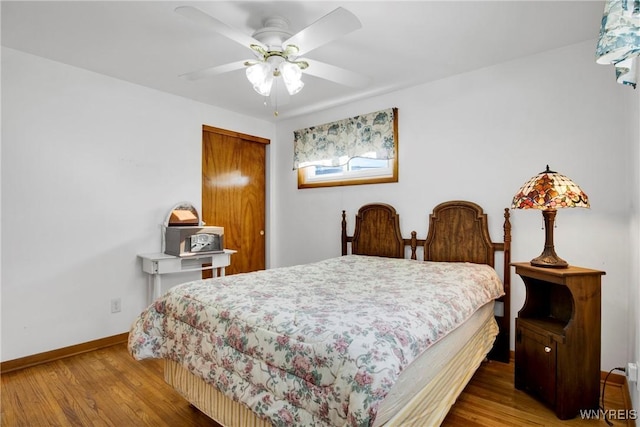 bedroom featuring ceiling fan, hardwood / wood-style floors, and a closet