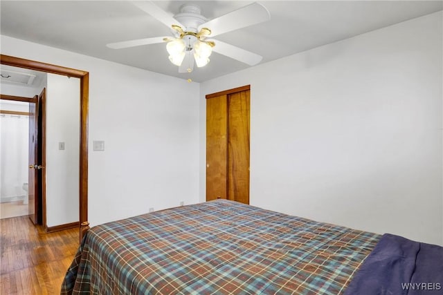 bedroom featuring hardwood / wood-style floors, ceiling fan, and a closet