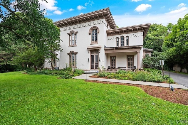 italianate house with covered porch and a front lawn