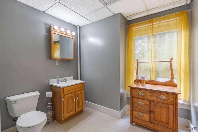 bathroom with vanity, a paneled ceiling, and toilet