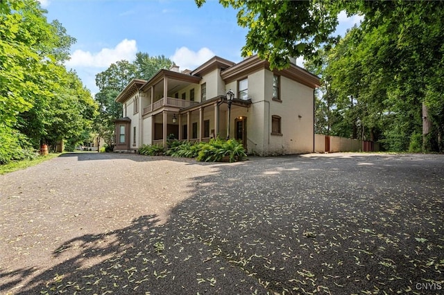 back of property featuring a balcony