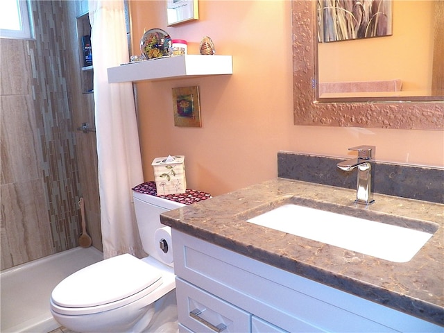 bathroom featuring vanity, toilet, and walk in shower