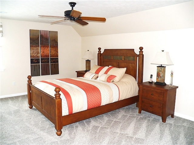 bedroom featuring vaulted ceiling, light colored carpet, and ceiling fan