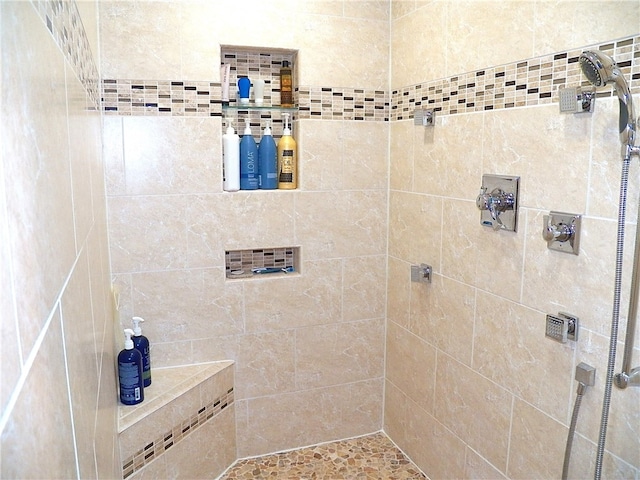 bathroom with tiled shower