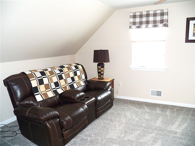 carpeted home theater featuring lofted ceiling