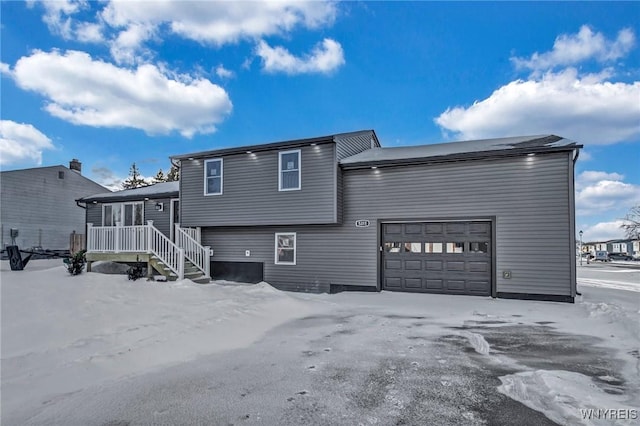 rear view of house with a garage