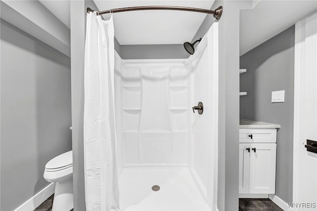 bathroom featuring a shower with curtain, vanity, toilet, and hardwood / wood-style flooring