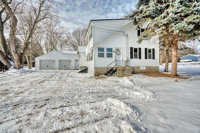 view of front of home featuring a garage and an outdoor structure