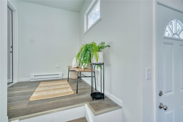 entrance foyer featuring hardwood / wood-style floors and a baseboard heating unit