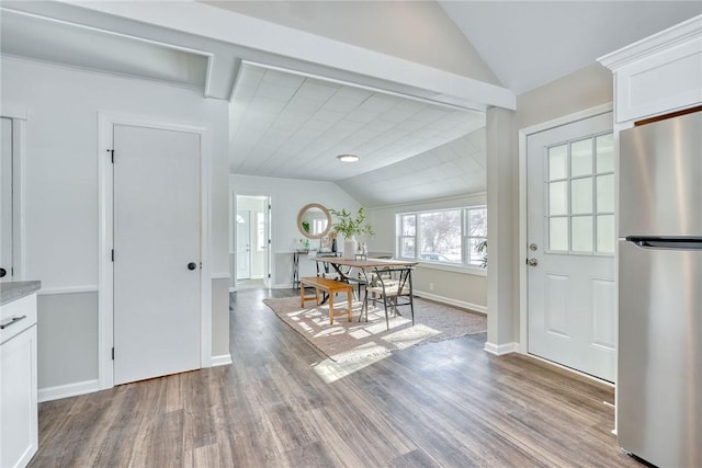 interior space with lofted ceiling and light hardwood / wood-style flooring