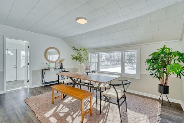 dining space with lofted ceiling and dark hardwood / wood-style floors