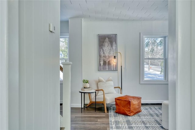 living area with hardwood / wood-style flooring and ornamental molding