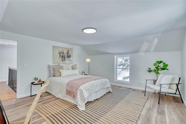 bedroom featuring light hardwood / wood-style flooring and vaulted ceiling