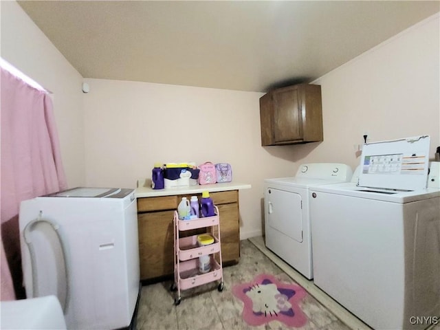 laundry room featuring cabinets and separate washer and dryer