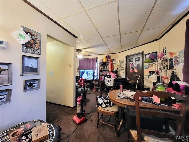 carpeted dining room with a drop ceiling