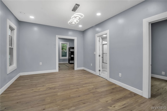 spare room featuring wood-type flooring