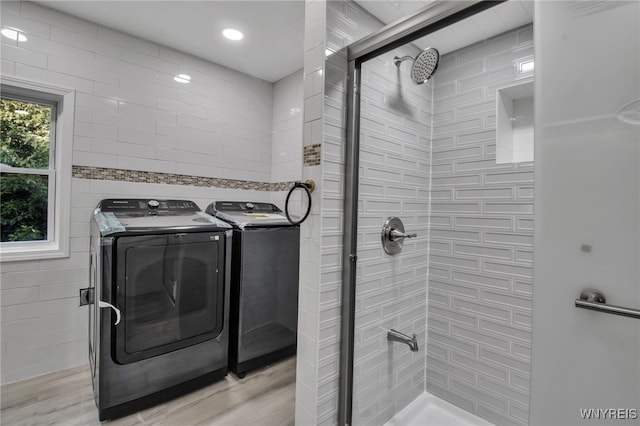 laundry room featuring light hardwood / wood-style floors and washer and dryer