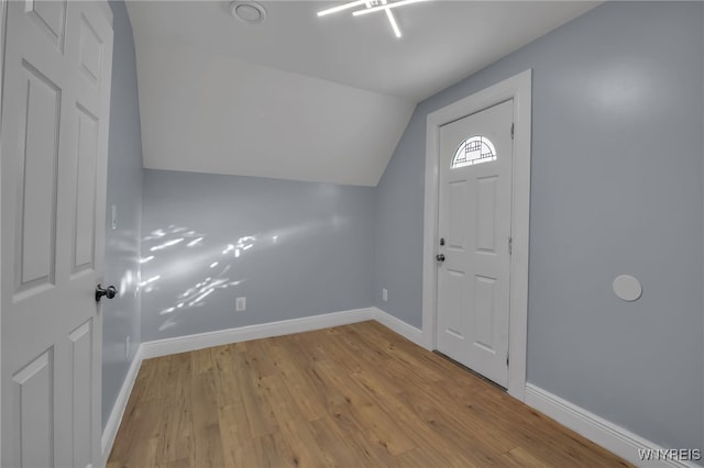 foyer entrance featuring lofted ceiling and light hardwood / wood-style floors