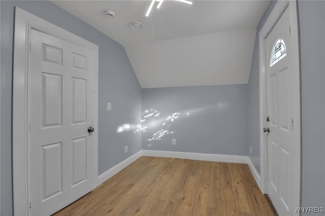 bonus room with vaulted ceiling and light hardwood / wood-style floors