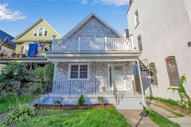 view of front of home with a porch and a balcony