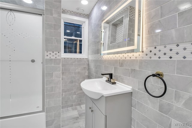 bathroom with vanity and tile walls