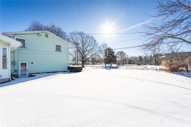 view of yard layered in snow