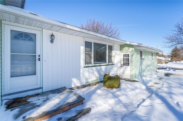 view of snow covered property entrance