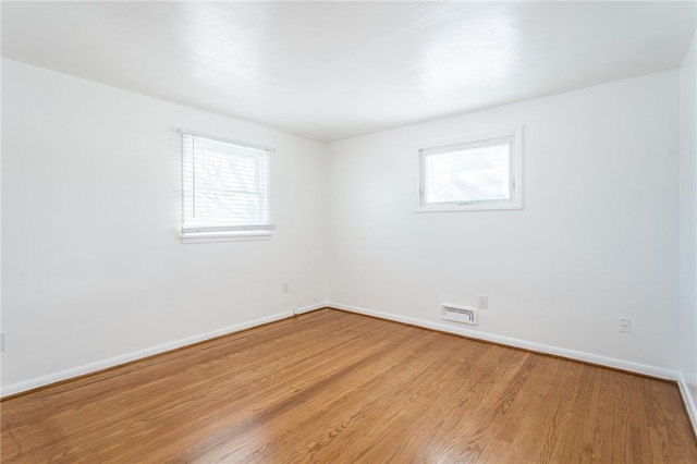 unfurnished room with light wood-type flooring