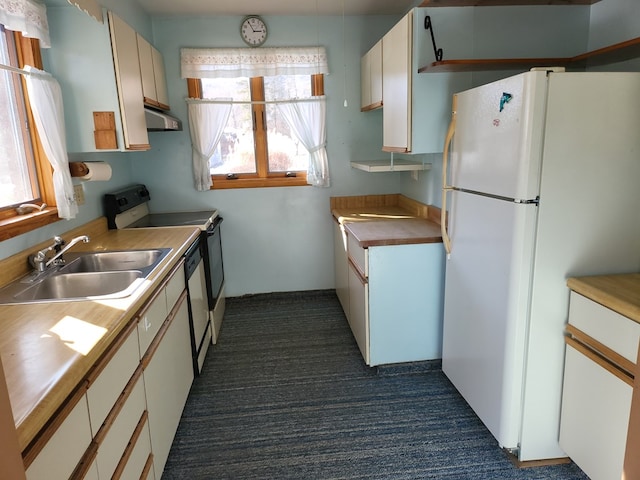 kitchen with sink, white cabinetry, range with electric stovetop, exhaust hood, and white fridge