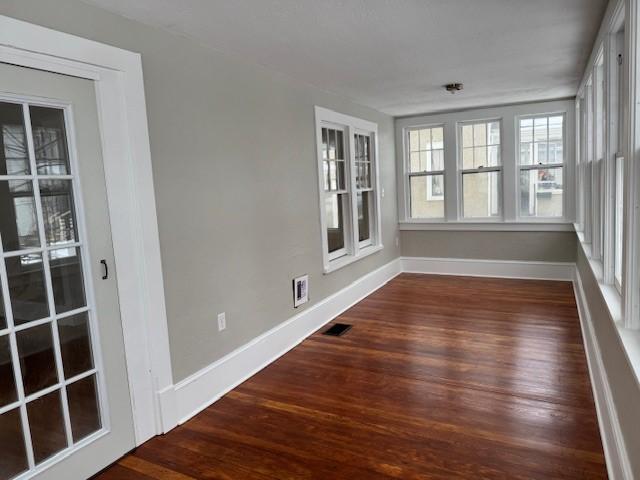 unfurnished sunroom with visible vents