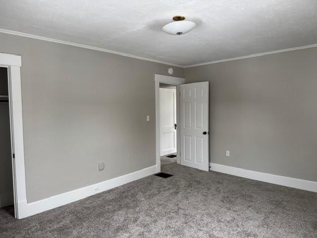 unfurnished bedroom with a closet, carpet flooring, baseboards, and ornamental molding