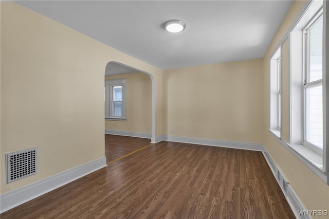 spare room featuring dark hardwood / wood-style flooring