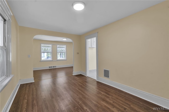 empty room featuring dark hardwood / wood-style flooring