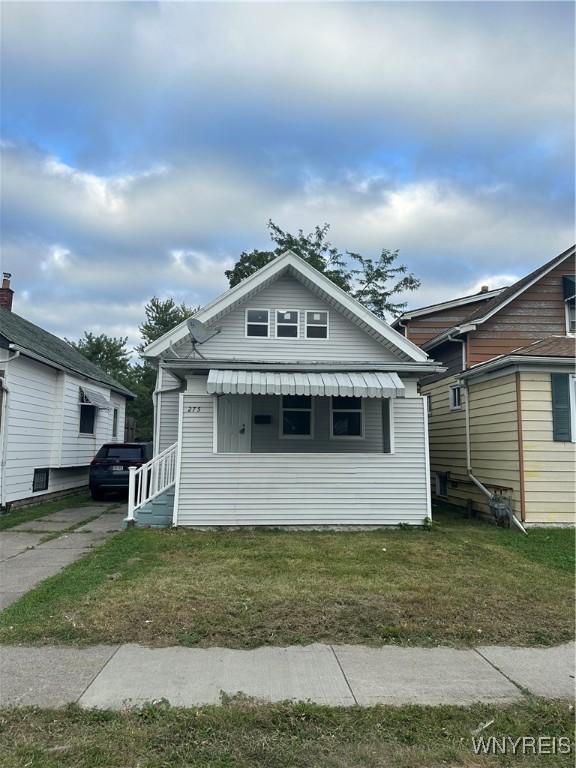 bungalow-style home featuring a front lawn