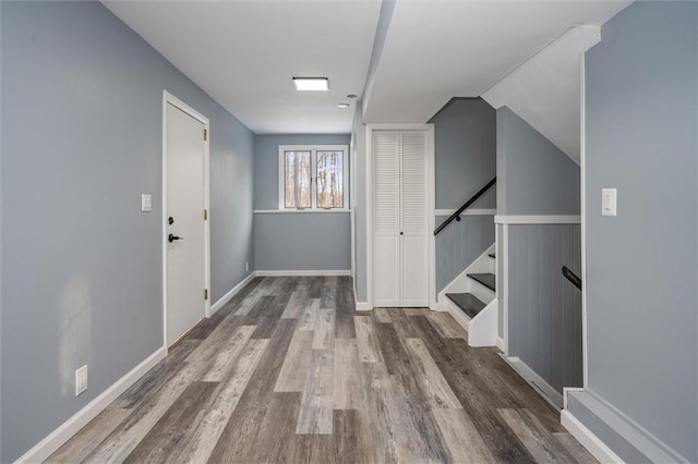 hall with lofted ceiling and dark hardwood / wood-style floors