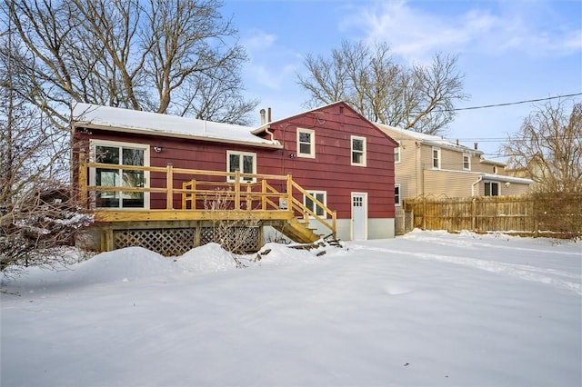 snow covered property featuring a deck